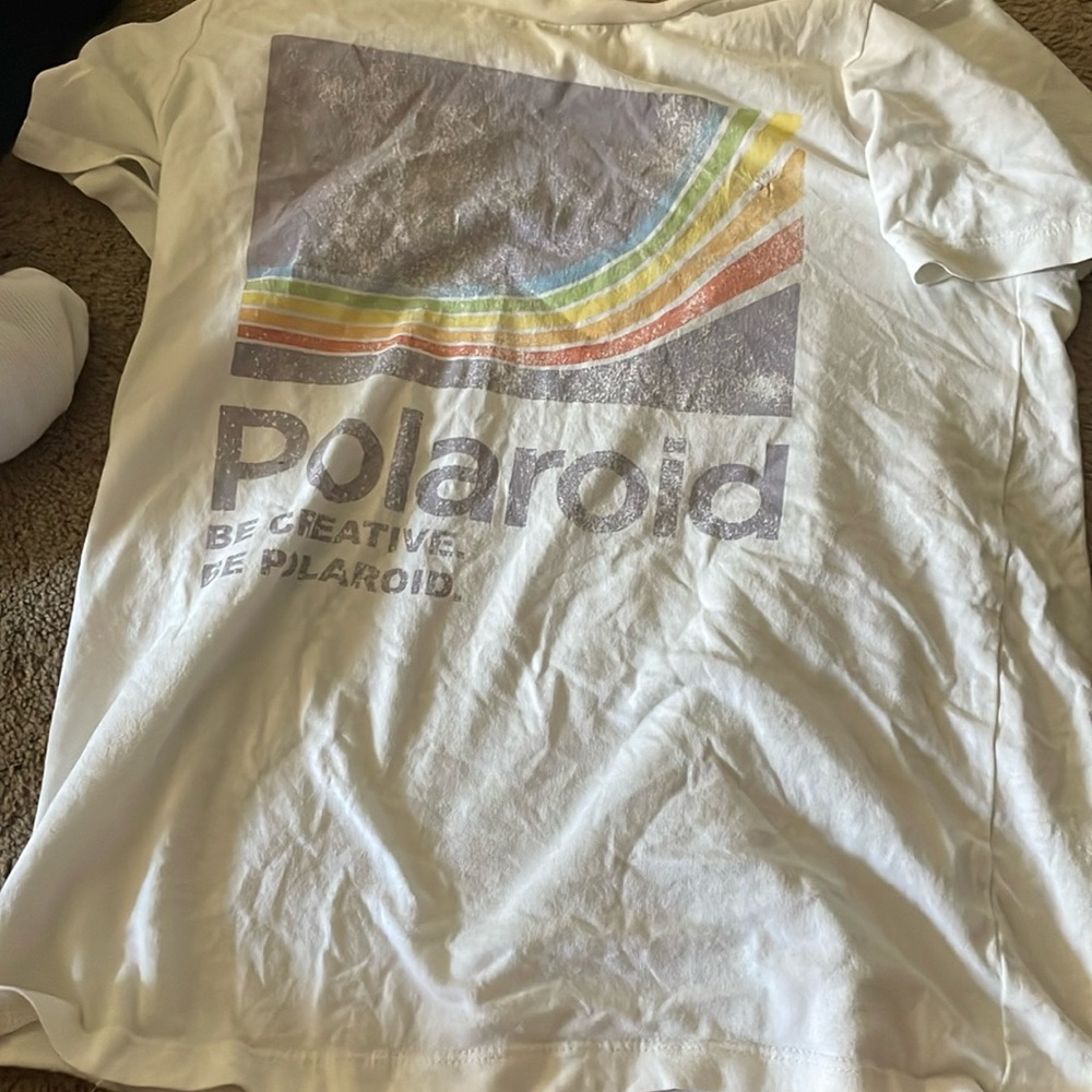 Polaroid brand. Based off camera. Has 2 holes. 1 on the back and 1 on the front